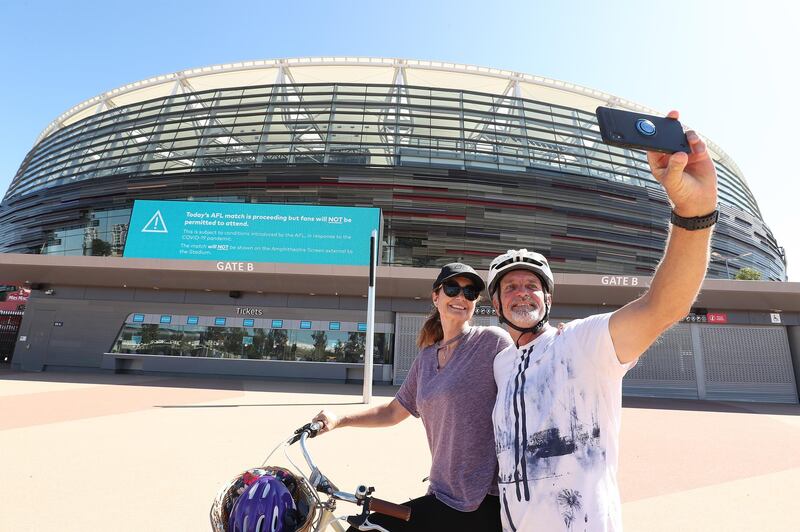 A couple takes a selfie in front of Optus Stadium in Perth. Getty Images