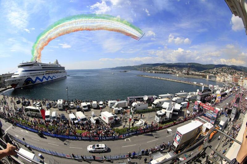 Italian Air Force aerobatic unit “Frecce Tricolori” drag green, white and red smoke in the colours of the Italian flag over the finish line of the 21st and last stage of the 97th Giro d’Italia (Tour of Italy) cycling race, 172km from Gemona to Trieste. Luk Benis / AFP 