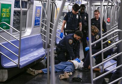 Police officers administer CPR to Jordan Neely on a subway train, in New York, on May 1. AP