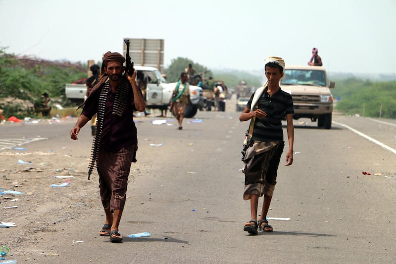 epa06768608 Yemeni government forces backed by the Saudi-led coalition take position at an area after seizing it from the Houthi militia in the western province of Hodeidah, Yemen, 27 May 2018 (issued 28 May 2018). According to reports, Yemeni troops backed by the Saudi-led coalition have moved closer to a key Houthis-held port and strategic city of Hodeidah after Yemeni government forces seized Houthis-held areas along the western coast. Most of Yemen's food and medicine imports and aid are shipped through Hodeidah port.  EPA/STRINGER