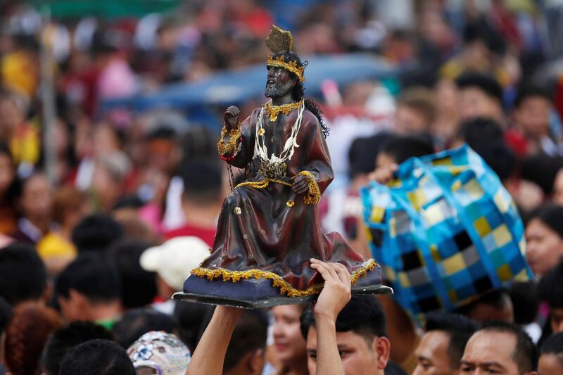 Catholic devotees celebrate as they wait to touch the statue of the Black Nazarene. Reuters