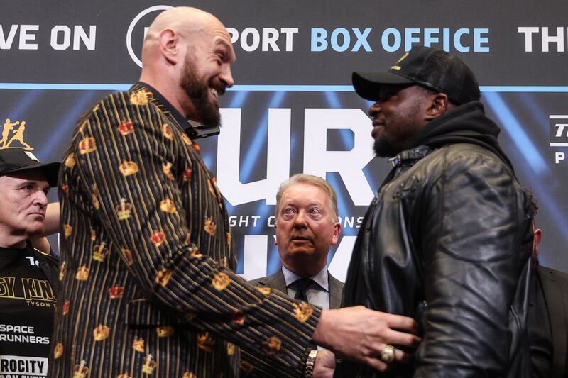 WBC heavyweight title holder Britain's Tyson Fury tries to tickle Dillian Whyte at the Wembley Stadium. AFP