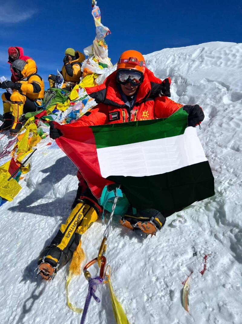 Nayla Al Baloushi unfurls the flag on Everest. Photo: Nayla Al Baloushi