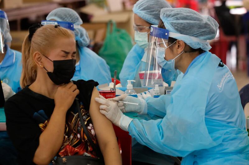 A health worker administers a dose of the Sinovac COVID-19 vaccine for a woman in Bangkok, Thailand. AP Photo