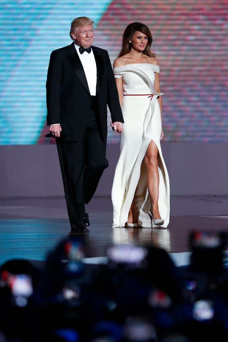 epa05737035 US President Donald J. Trump (L) and his wife First Lady Melania Trump (R) arrive at the Liberty Ball after being sworn in as the 45th President of the United States in Washington, DC, USA, 20 January 2017. Trump won the 08 November 2016 election to become the next US President.  EPA/SHAWN THEW