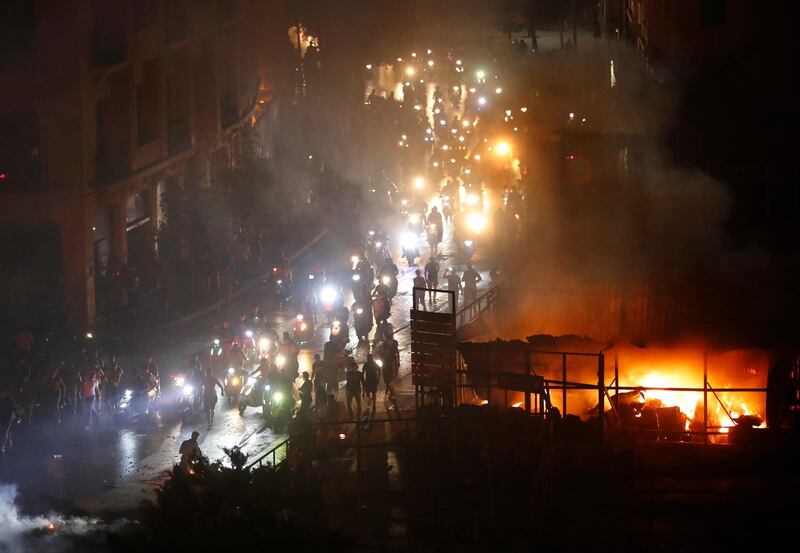 Protesters arrive on two-wheelers at a square near the government palace in Beirut. AP Photo