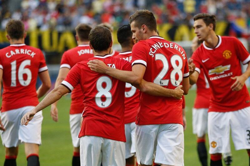 Juan Mata congratulates Morgan Schneiderlin after his goal to provide the difference in the 1-0 International Champions Cup pre-season tournament win over Club America of Mexico on Friday night in the US. Otto Greule Jr / Bongarts / Getty Images