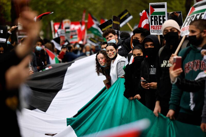 Pro-Palestinian activists and supporters in London wave flags and carry placards during a demonstration in support of the Palestinian cause as violence escalates in the conflict with Israel. AFP