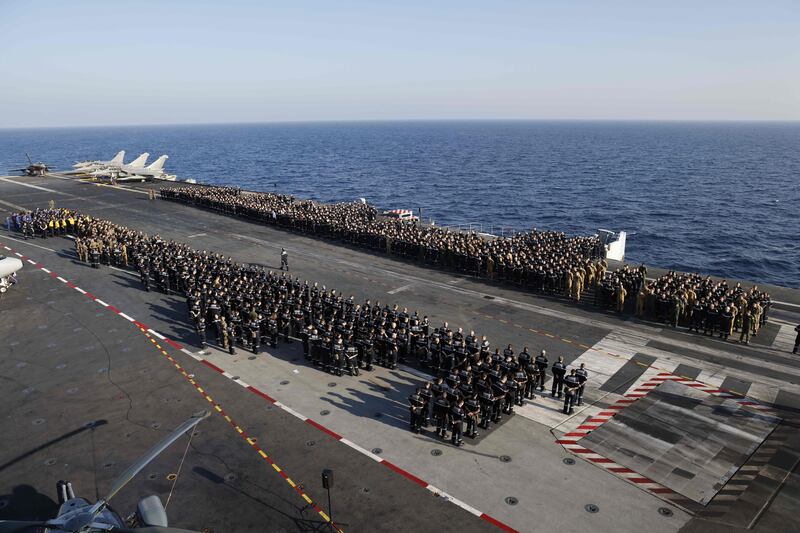 French naval personnel are briefed on the deck of aircraft carrier Charles de Gaulle, sailing between the Suez canal and the Red Sea. AFP