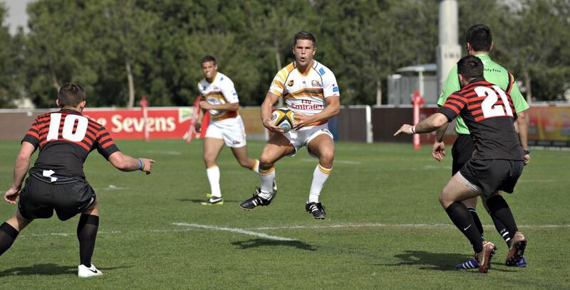 Abu Dhabi Saracens, in red, converge on a Dubai Hurricanes ball carrier. Saracens won 21-18 at The Sevens in Dubai City, Dubai on February 28, 2014. Jeff Topping for The National