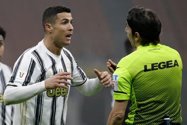 Juventus' Cristiano Ronaldo argues with the referee after receiving a yellow card during the Italian Cup semi-final first leg soccer match between Inter Milan and Juventus at the San Siro stadium, in Milan, Italy, Tuesday, Feb. 2, 2021. (AP Photo/Luca Bruno)