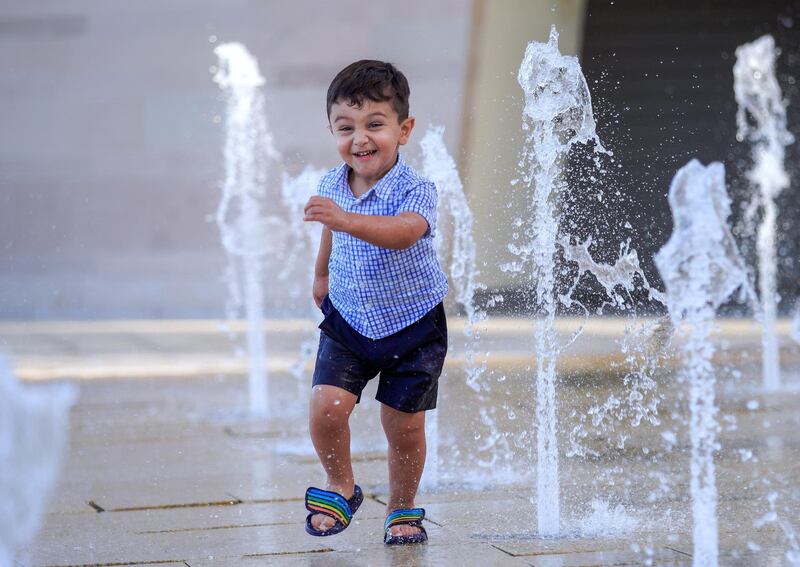 Abu Dhabi, United Arab Emirates, October 26, 2020.  The "new norm" of Covid-19 precautionary measures at Umm Al Emarat Park, Abu Dhabi, on a Monday afternoon.  Yusuf Helfawi, 2, enjoys one of the many water fountains at the park.
Victor Besa/The National
Section:  NA
Reporter: