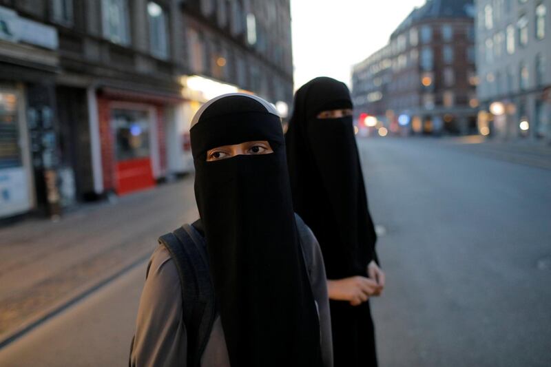 Sabina, 21 and Alaa, 22, wearers of the Islamic face veil known as the niqab, prepare to cross the street in the Norrebro neighborhood in Copenhagen, Denmark, July 30, 2018.  REUTERS/Andrew Kelly