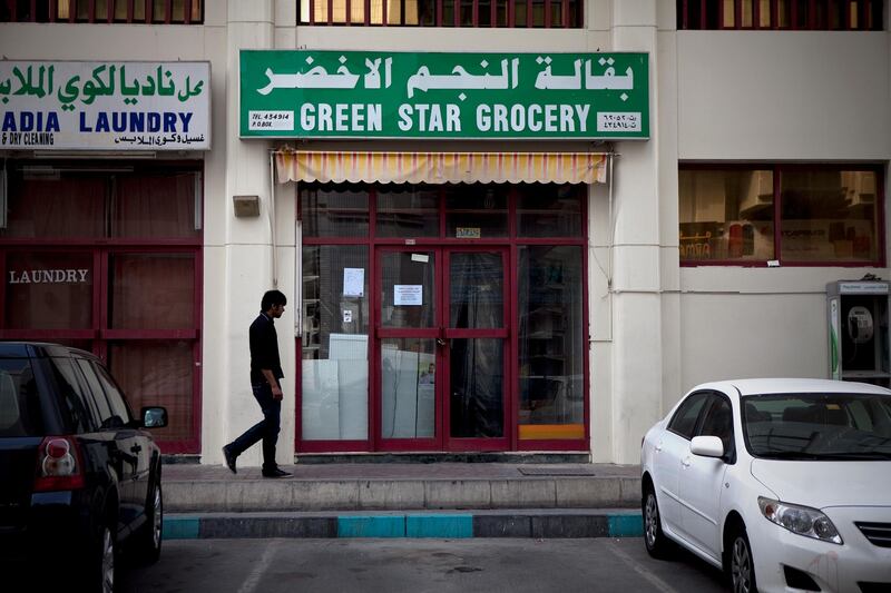 Abu Dhabi, United Arab Emirates, January 10, 2013: 
A man walks by the Green Star Grocery, a recently closed convenience store on Thursday, Jan. 10, 2013, in the city block between Airport and Muroor, and Delma and Mohamed Bin Khalifa streets in Abu Dhabi. 
Silvia Razgova/The National

