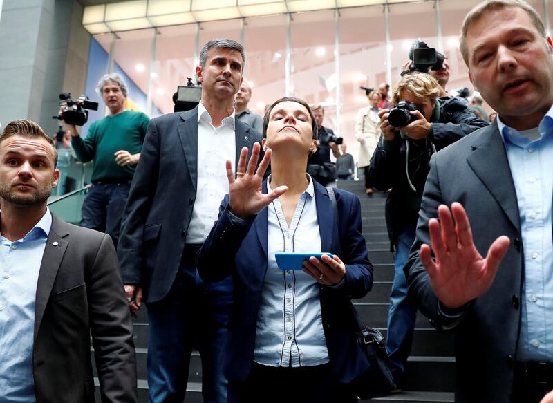 Frauke Petry (C), chairwoman of the anti-immigration party Alternative fuer Deutschland (AfD) reacts as she leaves a news conference in Berlin, Germany, September 25, 2017. REUTERS/Fabrizio Bensch     TPX IMAGES OF THE DAY