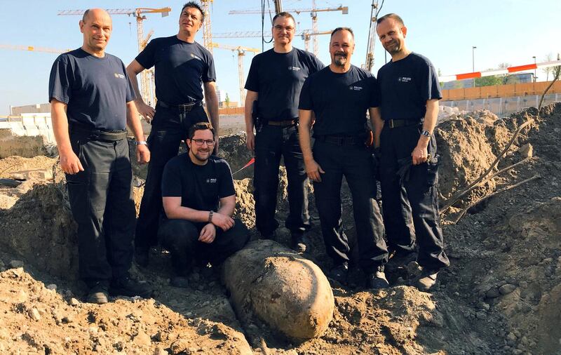 Bomb disposal experts pose next to the 500-kilogram Second World War bomb found near the main train station in Berlin, on April 20, 2018. Courtesy @polizeiberlin_e /Twitter/Handout via Reuters.