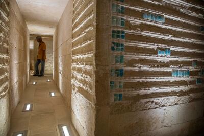 A worker stands inside the tomb, after its restoration. AP