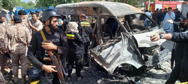 Pakistani security officials inspect the scene of an explosion in Karachi, Pakistan, 26 April 2022.  At least Four people were killed including Chinese nationals when a vehicle exploded near Karachi University.   EPA / SHAHZAIB AKBER