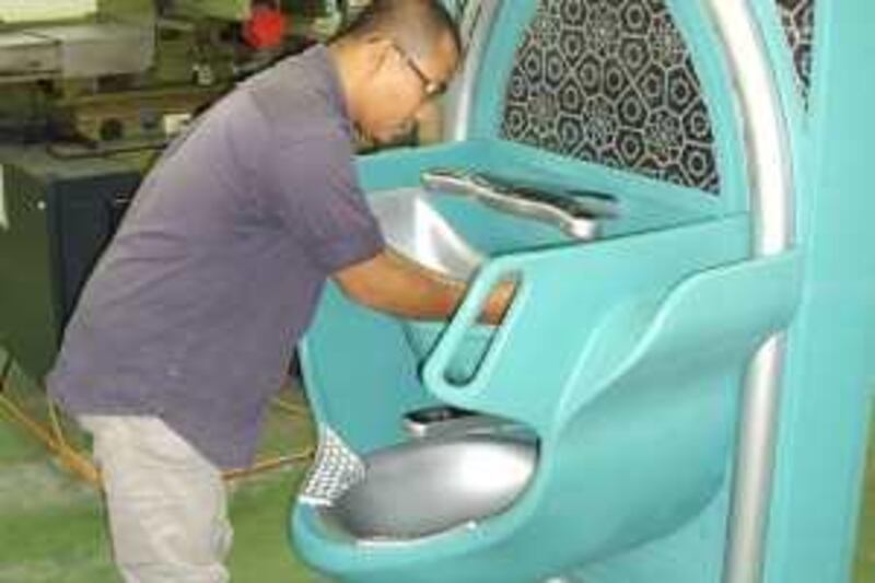An employee of AACE Technology demonstrates the use of the Auto Wudu Washer at the compnaies plant in Malaysia.

Credit: Courtesy of AACE Technology
