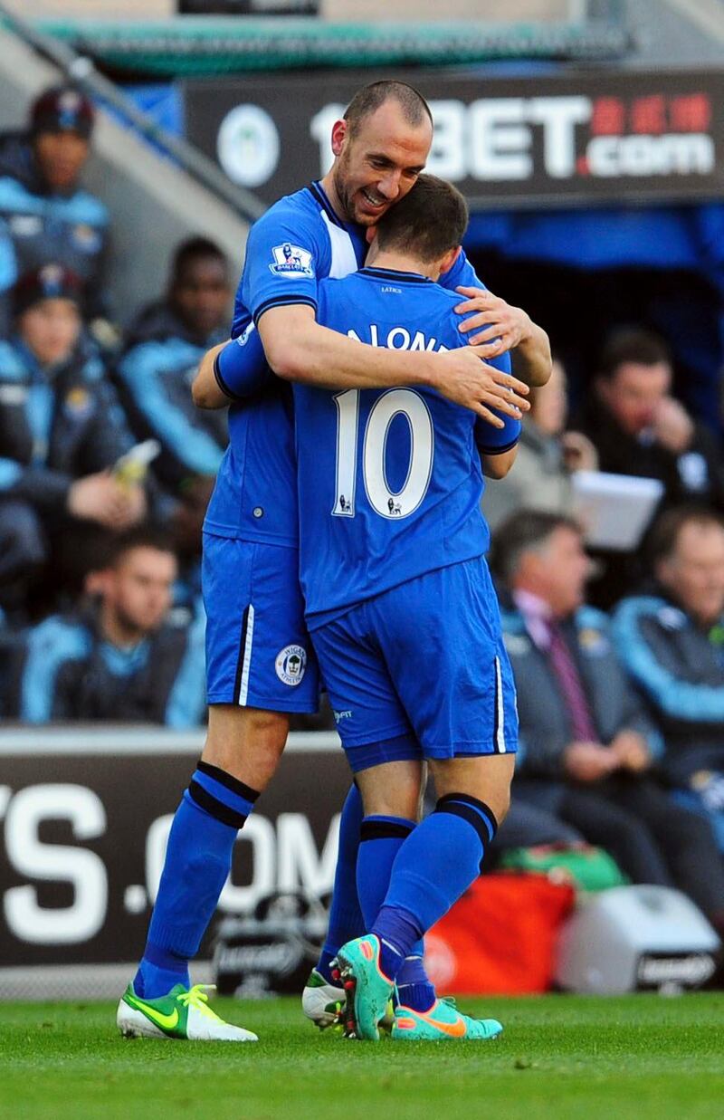 Wigan Athletic's Ivan Ramis, left, celebrates scoring against West Ham United with teammate Shaun Maloney during the English Premier League soccer match at the DW Stadium, Wigan, England, Saturday Oct. 27, 2012. Wigan won the match 2-1. (AP Photo/PA, Anna Gowthorpe) UNITED KINGDOM OUT  NO SALES  NO ARCHIVE *** Local Caption ***  Britain Soccer Premier League.JPEG-06407.jpg