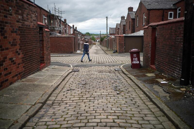 A back alley in Bolton, where surge testing and rapid coronavirus vaccinations continue. The UK government amended earlier advice asking people to avoid non-essential travel to and from Bolton, in the north, and seven other places in England experiencing a surge in Covid-19 case numbers. New guidance asks that people minimise travel to such places, whose local authorities were surprised by the initial rule change, published without fanfare on a government website on May 14. Getty Images