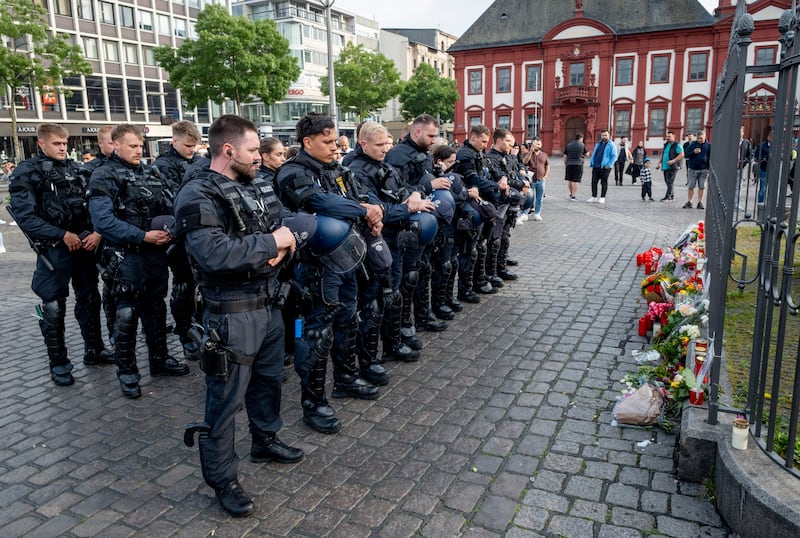 German police officers in Mannheim, Germany, after learning that a colleague, who was stabbed two days ago there, has died. AP