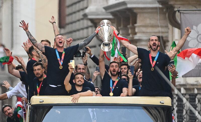 Italy's national football team parade with the UEFA EURO 2020 trophy on a double decker bus in Rome, following their defeat of England in the final match.