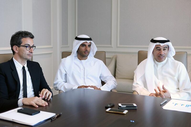 From left: Federico Marchetti, chief executive of Yoox Net-A-Porter Group, Rashid Alabbar, chairman of the joint venture between Symphony Investments and Yoox Net-A-Porter, and Mohamed Alabbar, chairman of Symphony Investments, discuss their joint venture during an interview with The National. Satish Kumar / The National