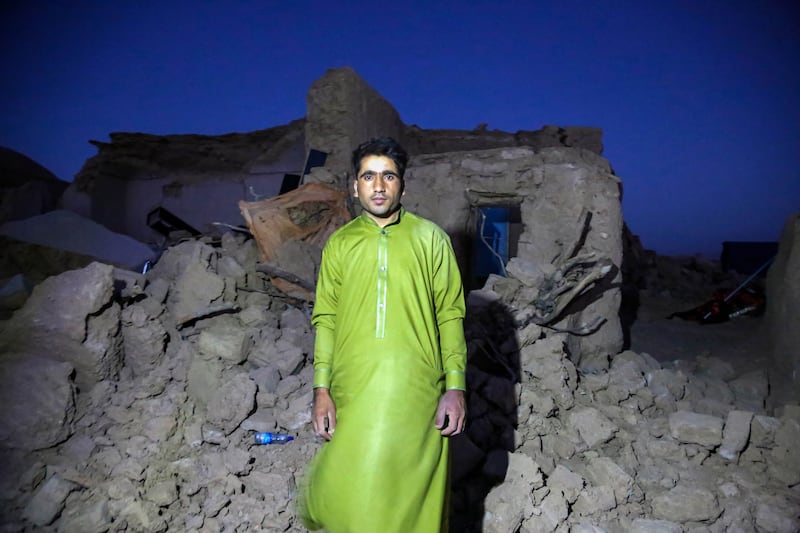 An Afghan man, at his destroyed home, waits for aid in the Zinda Jan district of Herat. EPA