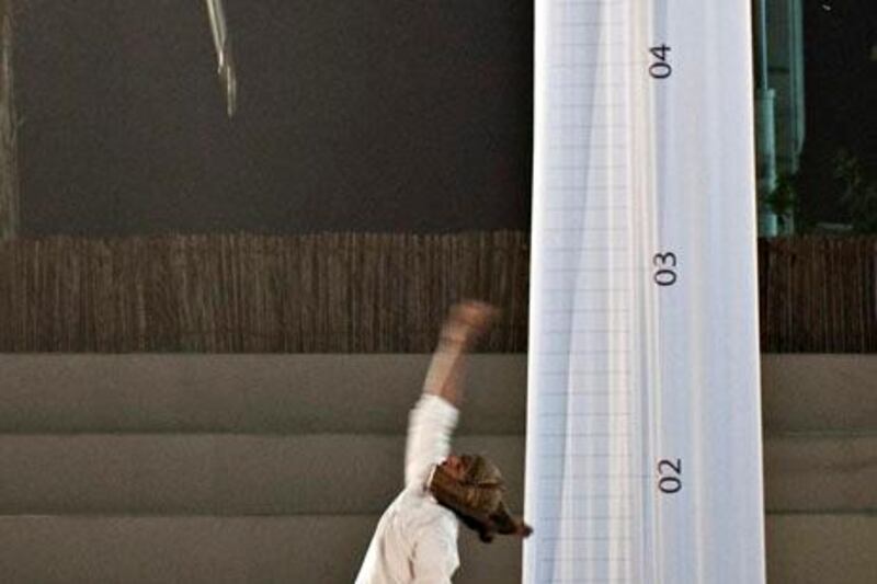 Hazza Suleiman al Shehhi, 18, attempts to set a Guiness World Record for the highest sword throw  at the Al Saif Traditional Sword Competition, Fujairah, UAE on Friday, November 26, 2010.