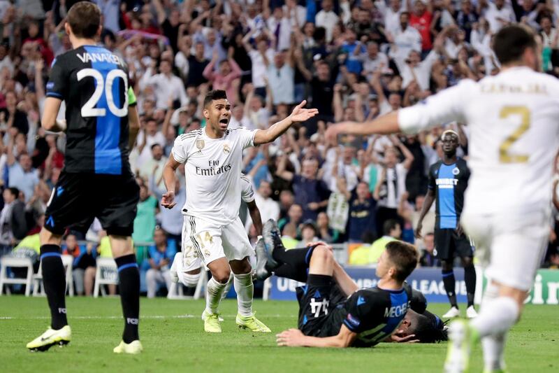 Real Madrid's Casemiro, center, celebrates after scoring his side's second goal during the Champions League group A soccer match between Real Madrid and Club Brugge, at the Santiago Bernabeu stadium in Madrid. AP Photo