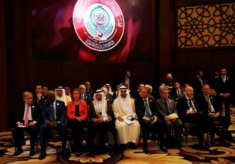 United Nations secretary-general Antonio Guterres, front row left, and the European Union foreign policy chief Federica Mogherini, front row 3rd left, sit with Arab leaders during the 28th Arab Summit. Mohammad Hamed / Reuters