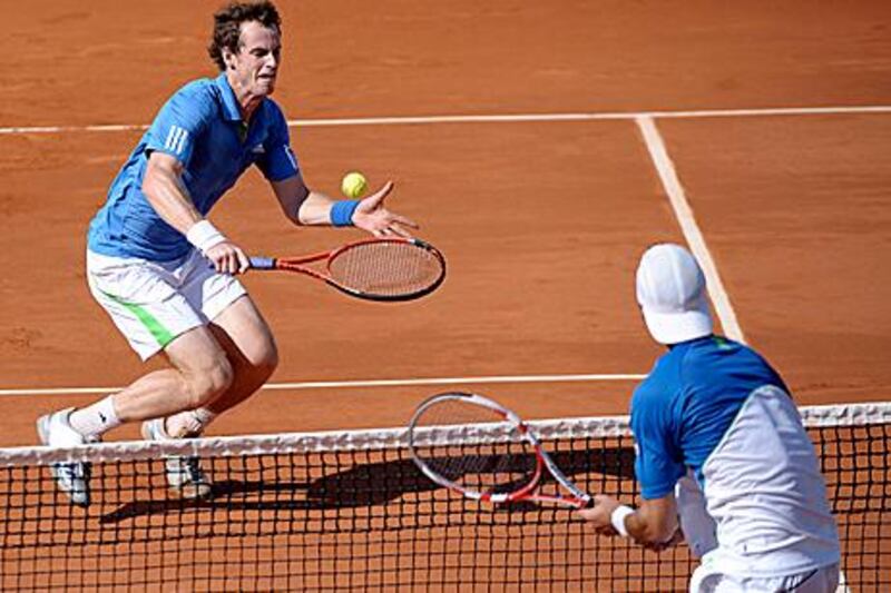 The British player Andy Murray, left, beat Juan Ignacio Chela of Argentina in straight sets to set up a semi-final with world No 1 Rafael Nadal.