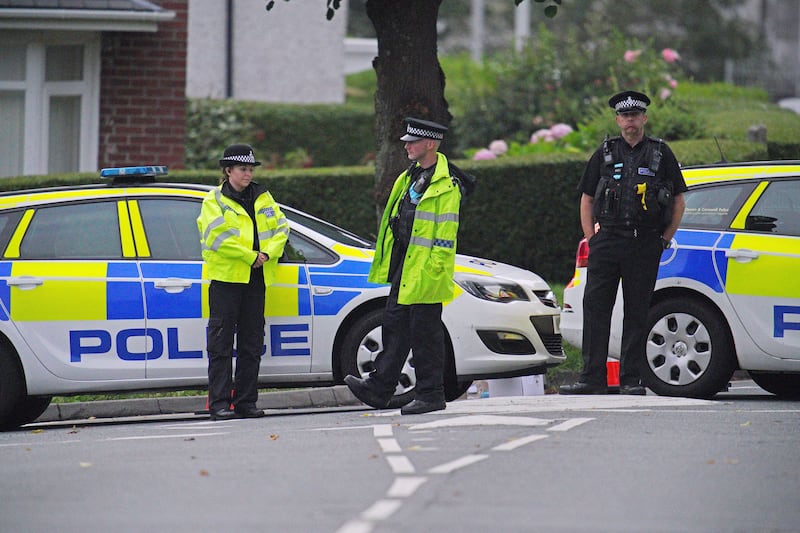 Police officers cordon off the scene of the crime in the Keyham district of Plymouth.