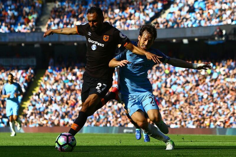 Hull City midfielder Ahmed Elmohamady, left, vies with Manchester City's  David Silva. City beat Hull 3-1 in Manchester. Geoff Caddick / AFP
