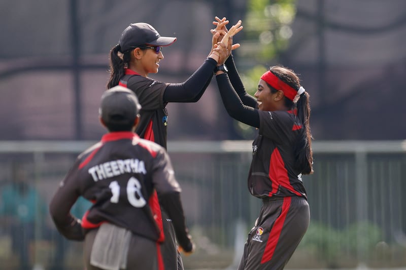 Mahika Gaur, left, and Indhuja Nandakumar of UAE celebrate the wicket of Mas Elysa Yasmin of Malaysia during the Women’s T20 Asia Cup 2022 cricket match at the Sylhet Outer Cricket Stadium, Sylhet, Bangladesh onOctober 5, 2022.