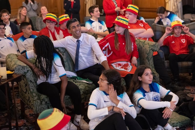Mr Sunak joins youth footballers from Wales and England to watch the World Cup match between the two nations. Photo: Simon Walker / No 10 Downing Street