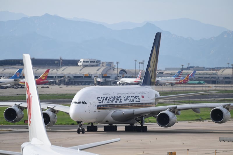 A Singapore Airlines Airbus A380 taxis before take-off at Beijing airport on July 25, 2018.  Beijing hailed "positive steps" as major US airlines and Hong Kong's flag carrier moved to comply on July 25 with its demand to list Taiwan as part of China, sparking anger on the island. A growing number of international airlines, including Qantas, Singapore Airlines, Qatar Airways, Emirates and KLM had already changed their websites from Taiwan to "Taiwan, China", while others skirt the issue by merely listing cities. / AFP / GREG BAKER
