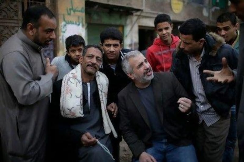 Anthony Shadid, middle right, interviews residents of Embaba, a lower-class Cairo neighborhood, during the Egyptian revolution. AP Photo