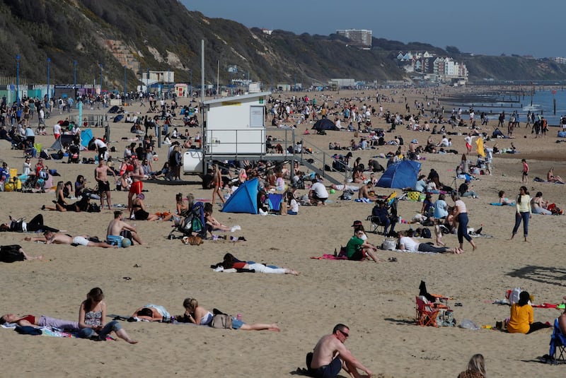 People enjoy the warm weather at Bournemouth beach, on England's south coast. Reuters