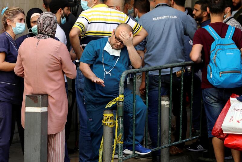 A healthcare worker gestures as he stands outside American University of Beirut medical centre in Beirut, Lebanon. Reuters