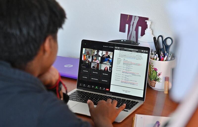 ALBUQUERQUE, NEW MEXICO - AUGUST 17: Kyalynn Moore-Wilson, a freshman, sits at a desk in her dorm room as she participates in a Zoom meeting for an 'Introduction to Psychology' course as classes begin amid the coronavirus (COVID-19) pandemic on the first day of the fall 2020 semester at the University of New Mexico on August 17, 2020 in Albuquerque, New Mexico. The course will meet in person four times during the fall semester with the remaining classes and coursework completed online. To help prevent the spread of COVID-19, the university has moved to a hybrid instruction model that includes a mixture of in-person and remote classes. According to the school, about 70 percent of classes are being taught online.   Sam Wasson/Getty Images/AFP
== FOR NEWSPAPERS, INTERNET, TELCOS & TELEVISION USE ONLY ==
