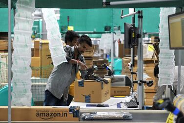 Indian employees work inside Amazon's largest Fulfillment Centre in India, on the outskirts of Hyderabad. NOAH SEELAM/AFP
