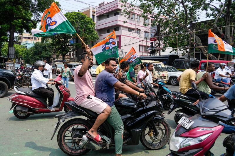Supporters of Trinamool Congress Party with party flags in Kolkata. AP Photo