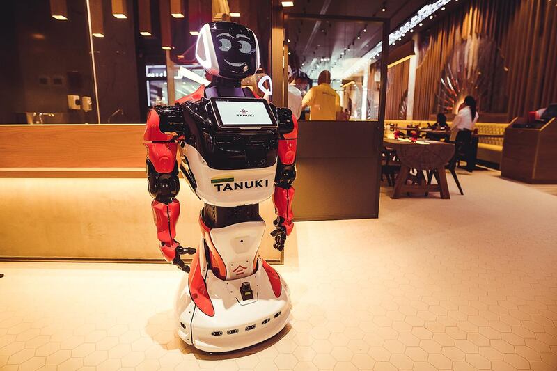 The robot sings, dances, and hands out food tokens at Tanuki restaurant. Courtesy Tanuki