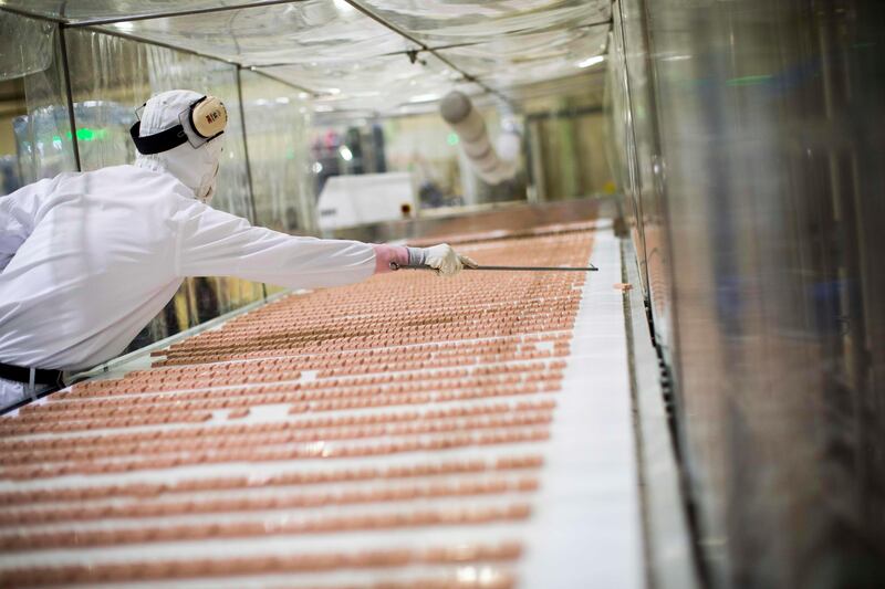 In this picture taken on August 24, 2017, a Japanese worker checks strawberry flavour KitKat bars on a production line at the KitKat factory in Inashiki, Ibaraki prefecture, northeast of Tokyo.
KitKats have been around in Britain since 1935 and only arrived in Japan in 1973, but the Japanese market has a crucial unique selling point -- a huge variety of different flavours. / AFP PHOTO / Behrouz MEHRI / TO GO WITH Japan-food-consumers by Anne Beade