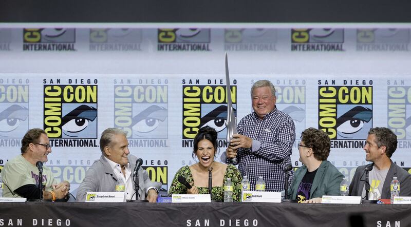 From left, Stephen Root, Dolph Lundgren, Tiffany Smith, William Shatner, Robert David, and Gregory Mone speak onstage at the 'Masters of the Universe: 40 Years' panel. AFP