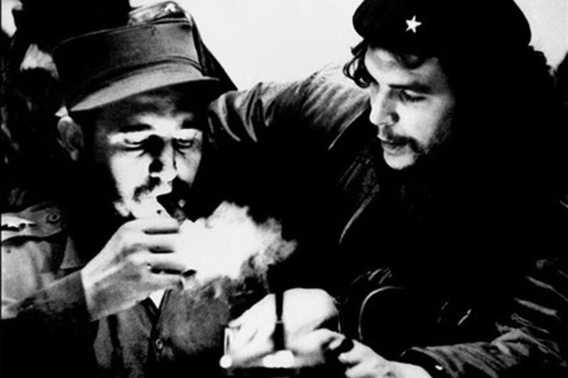 Argentinian rebel leader Ernesto Che Guevara talks to Fidel Castro as he lights a cigar when Castro was Cuban prime minister in the 1960s. AFP / Cubadebate / Roberto Salas