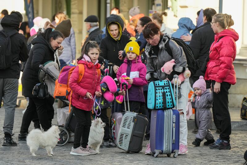 Refugees with children wait for a transport after fleeing the war from neighbouring Ukraine at a railway station in Przemysl, Poland. AP Photo