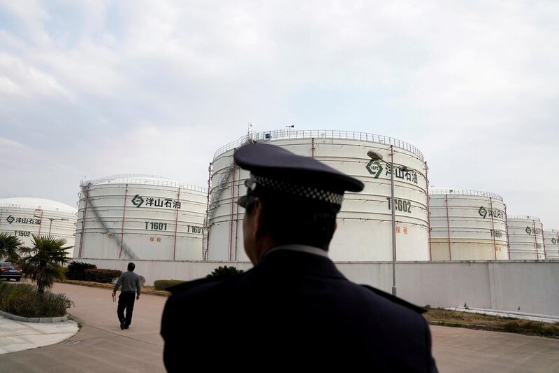 FILE PHOTO: Oil tanks are seen at an oil warehouse at Yangshan port in Shanghai, China March 14, 2018. REUTERS/Aly Song/File Photo
